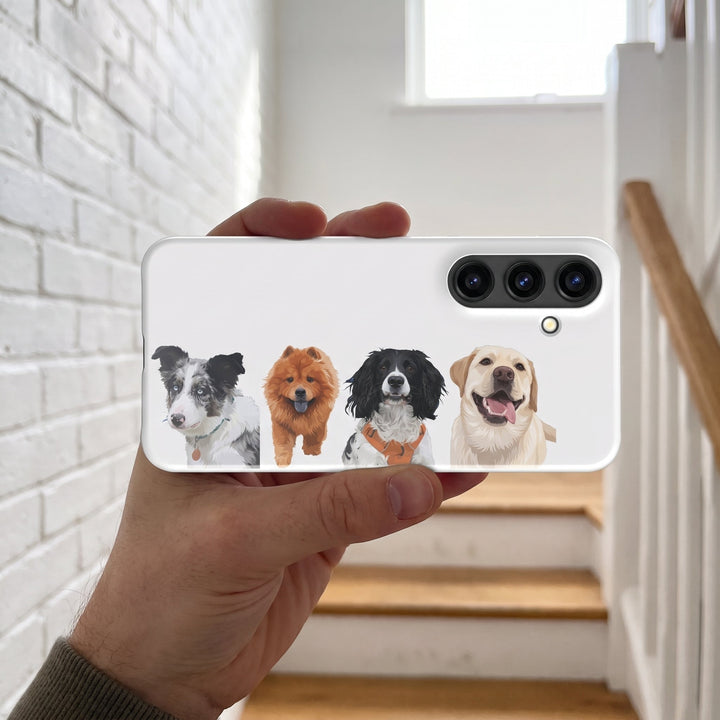 A hand holding a custom pet Galaxy phone case (Snap Glossy) featuring an illustration of Willow the Border Collie, Simba the Chow Chow, Roscoe the English Springer Spaniel & Sunny the Labrador Retriever up to the camera, in a bright staircase...