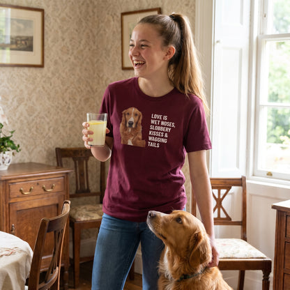 A teenage girl with a high ponytail wearing a custom pet t-shirt (Maroon) printed with "Love Is Wet Noses, Slobbery Kisses & Wagging Tails" and an illustration of Amber the Retriever (Toller type), with Amber beside them. [ks Colour=Maroon; kind=lifestyle]